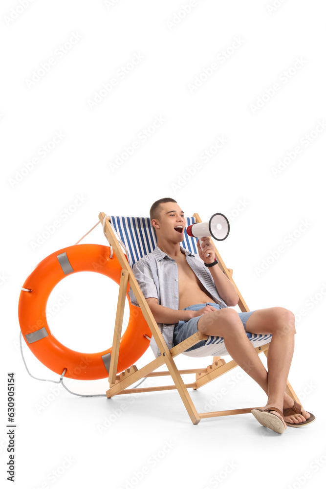 Teenage boy with megaphone in deck chair on white background