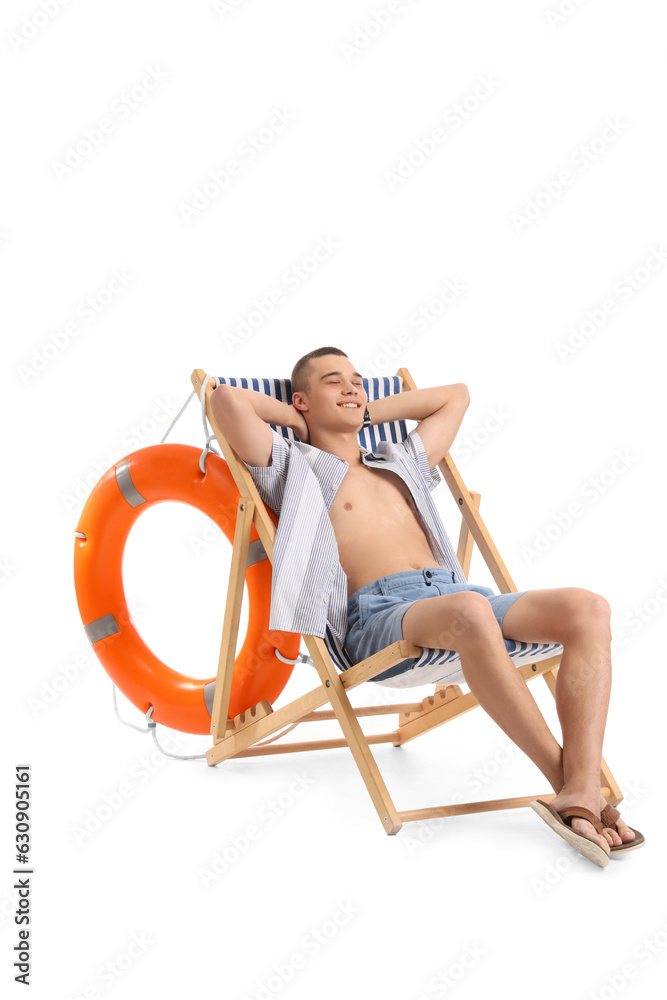 Teenage boy in deck chair on white background