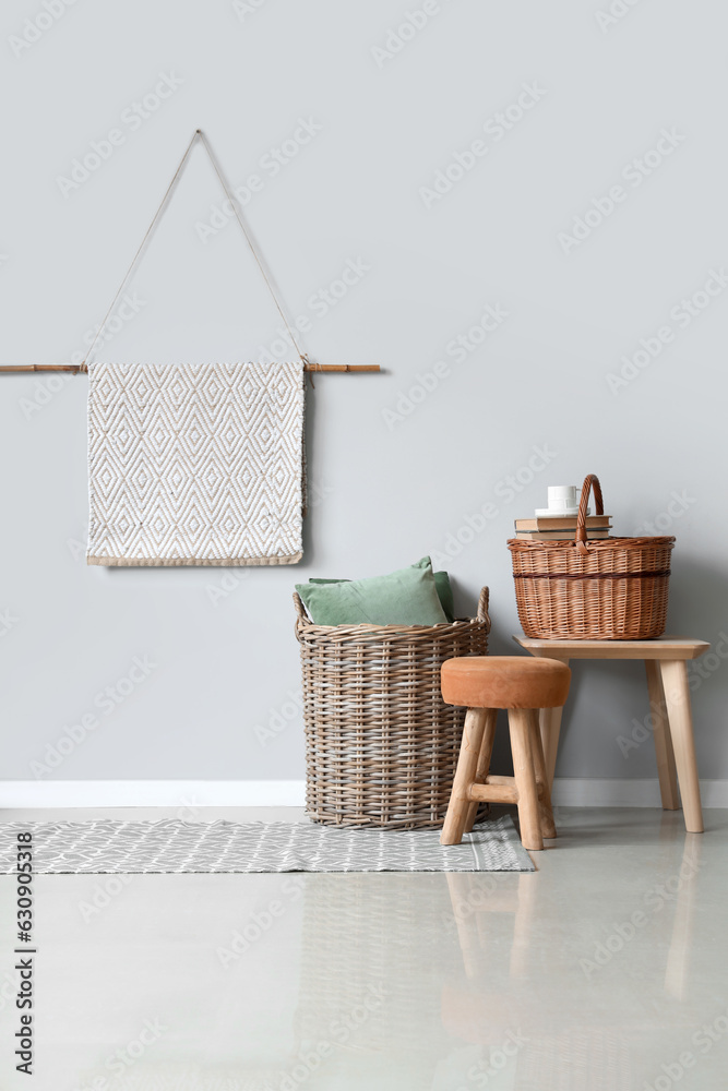 Interior of light living room with wicker baskets