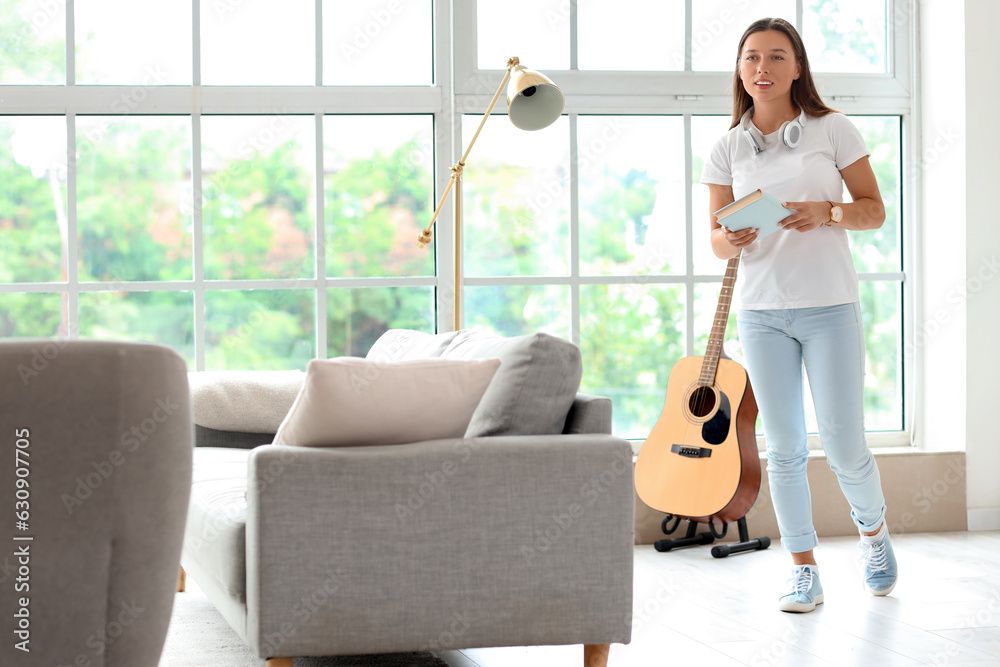 Young woman with book on her day off at home