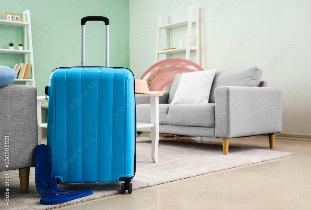 Suitcase with flip-flops in living room