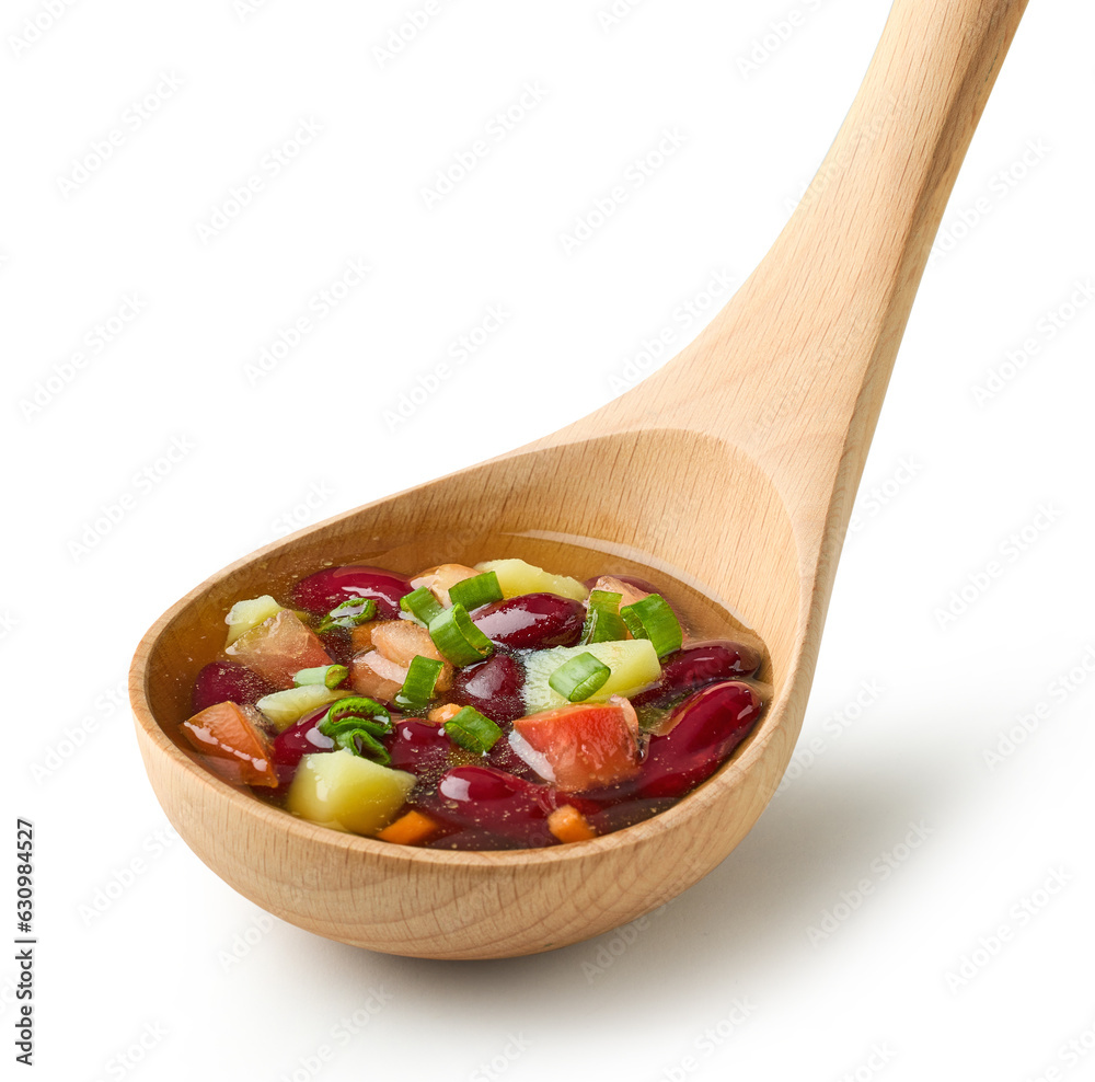 vegetable soup in wooden ladle