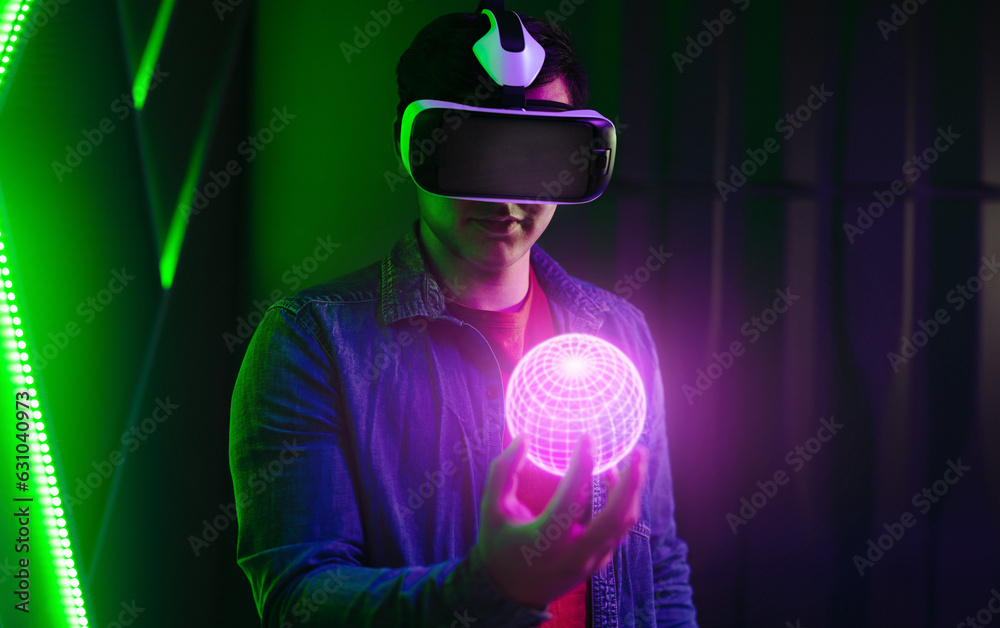 Young man wearing a VR headset and holding a virtual object