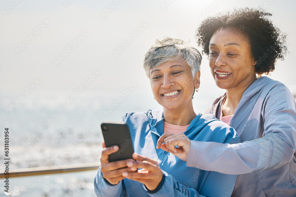 Senior woman, daughter and reading phone at the beach or social media, blog or post about workout or