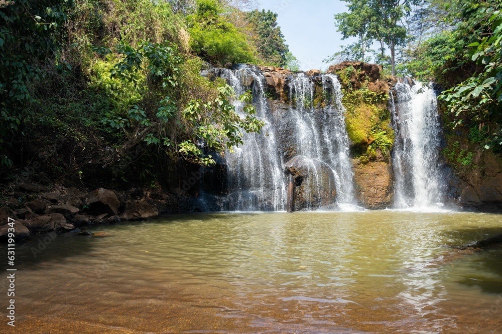 Landscape of the Katieng waterfall surrounded by greenery in Banlung, Cambodia