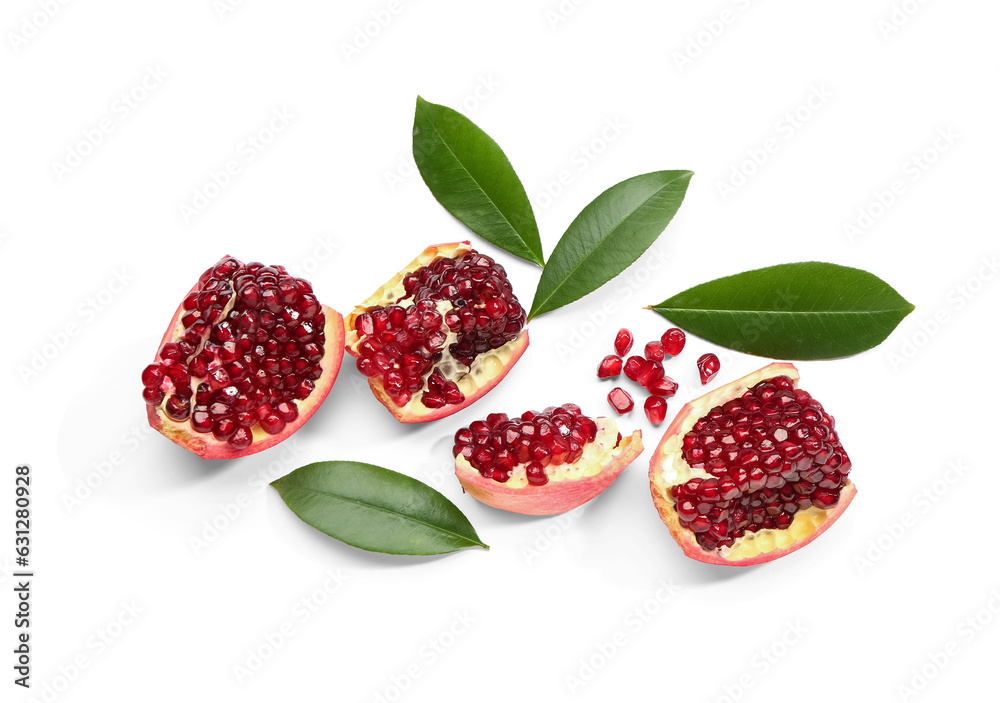 Pieces of fresh pomegranate and leaves on white background