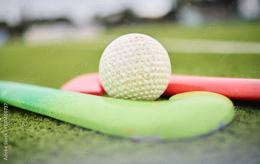 Hockey, stick and ball on a field for a game, training or exercise for sports. Closeup, ground and g