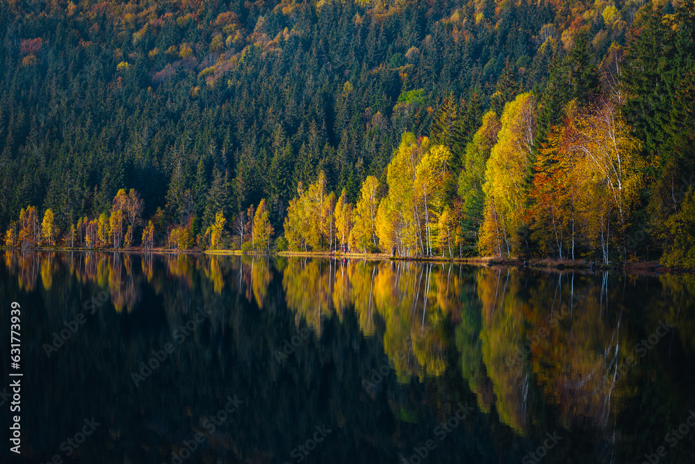 Majestic autumn scenery with Saint Ana lake and colorful forest