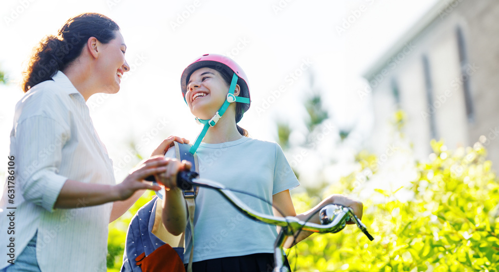 Girl in safety helmet with mother