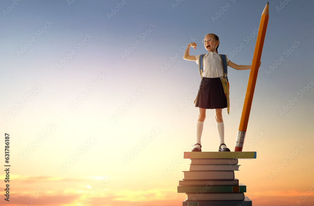 child on the tower of books