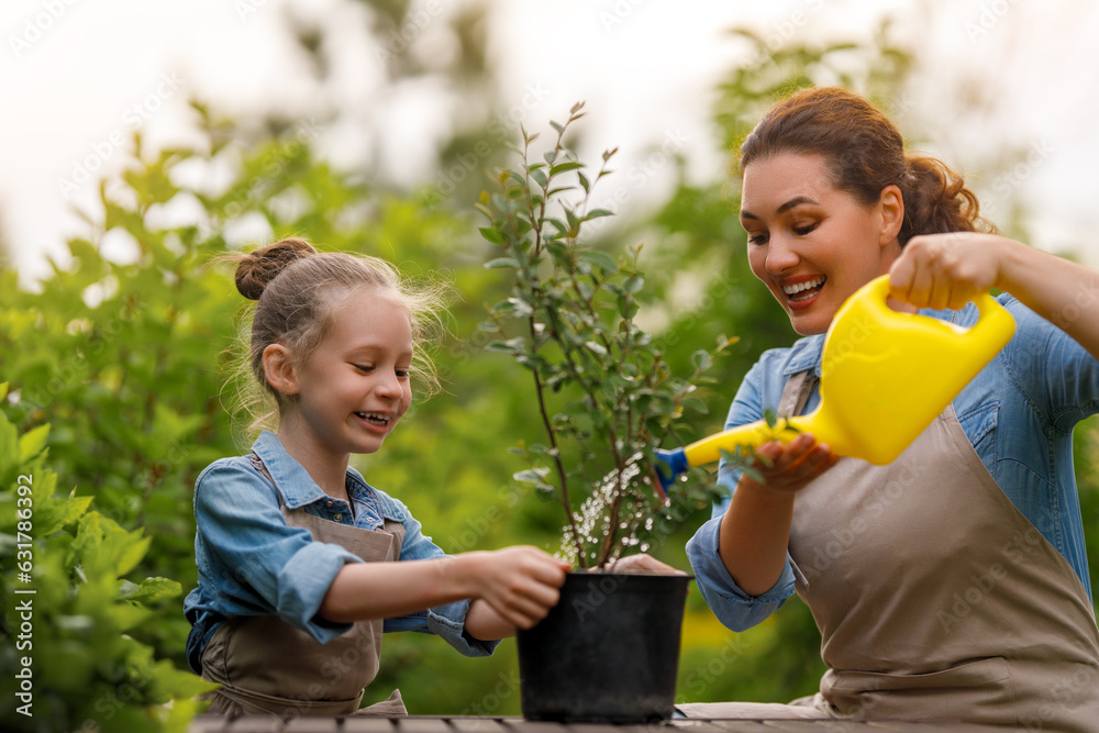 mother and daughter gardening in the backyard