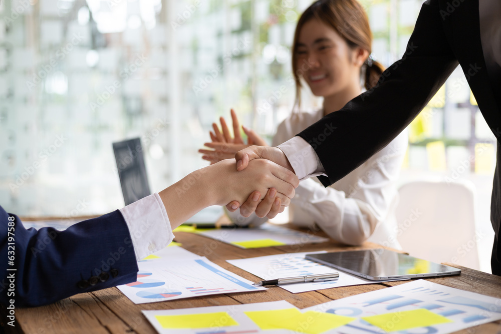 Business meeting, businesswomen shaking hands in business partnership meeting.