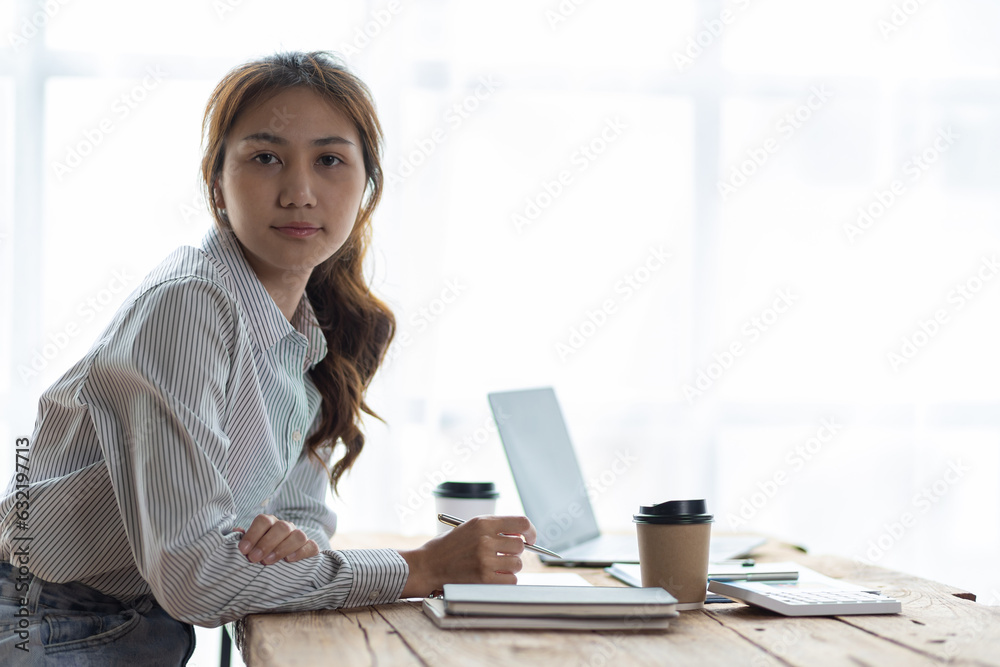 Portrait of a charming Asian businesswoman working in the office.