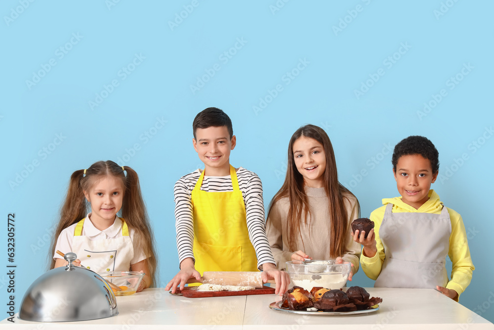 Group of little children during cooking class on blue background