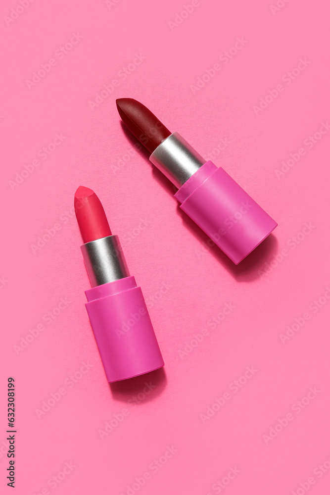 Different lipsticks on pink background