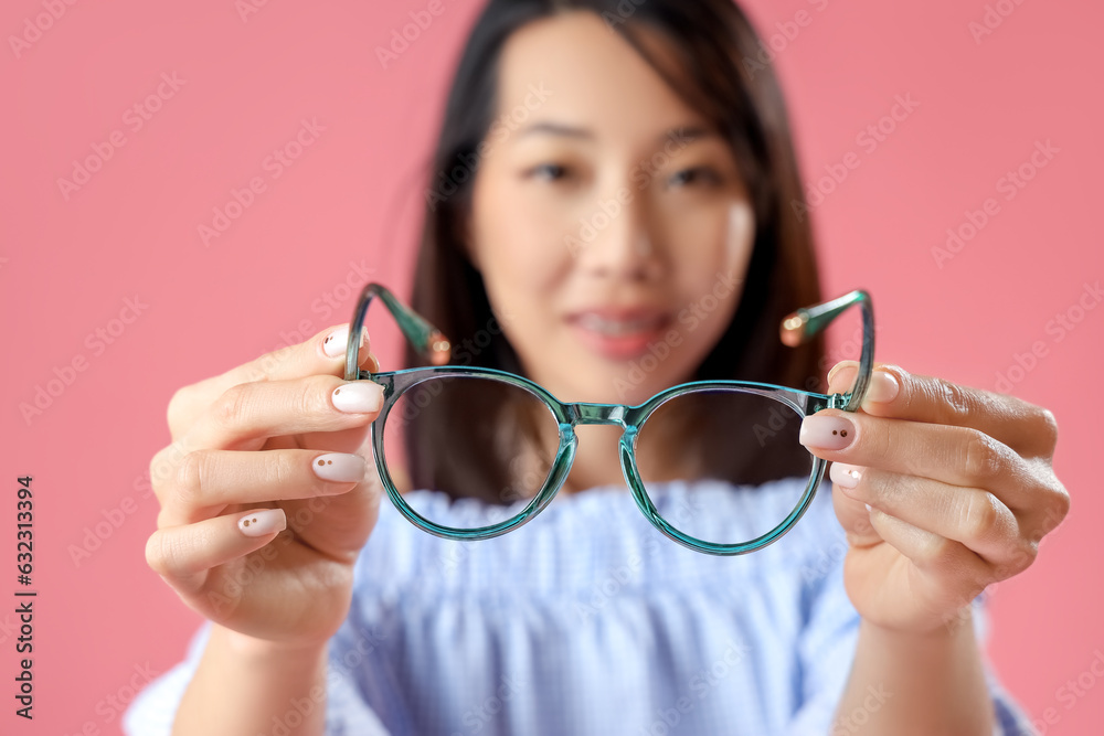 Beautiful Asian woman with stylish eyeglasses on pink background, closeup