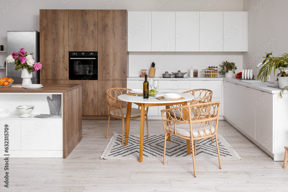 Served dining table in interior of light kitchen