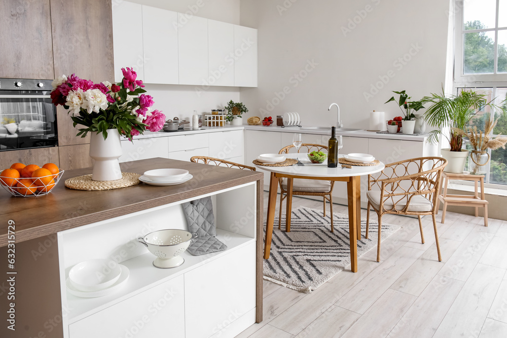 Served dining table in interior of light kitchen