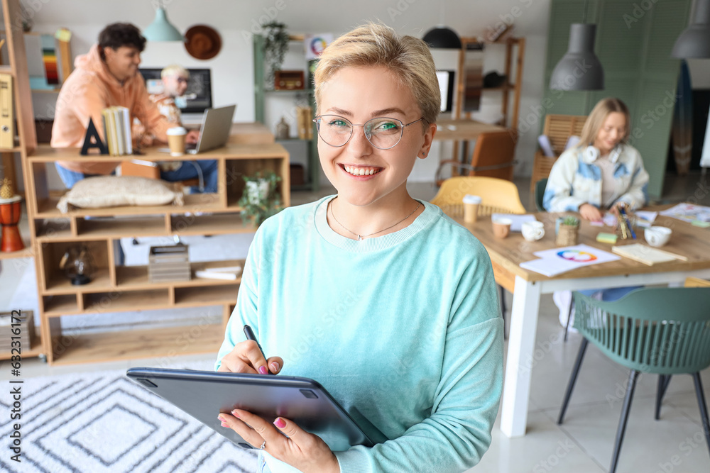 Female graphic designer working with tablet in office