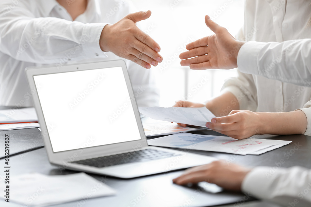 Male business consultant working with laptop at table in office, closeup