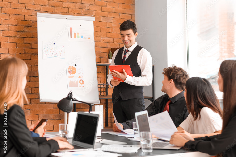 Male business consultant giving presentation to his colleagues in office