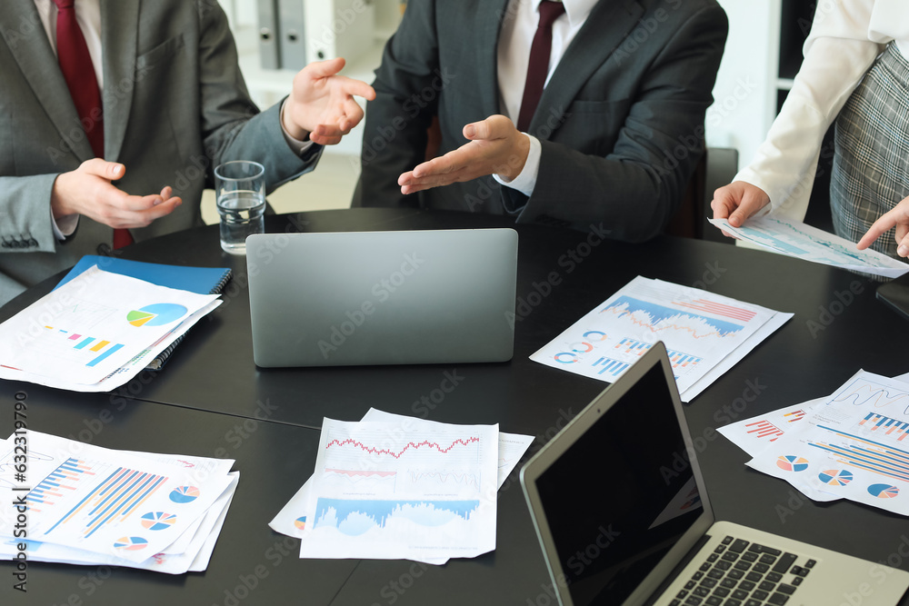 Group of business consultants working at table in office