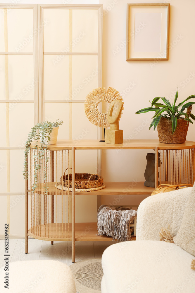 Modern living room interior with shelving unit, plants and folding screen