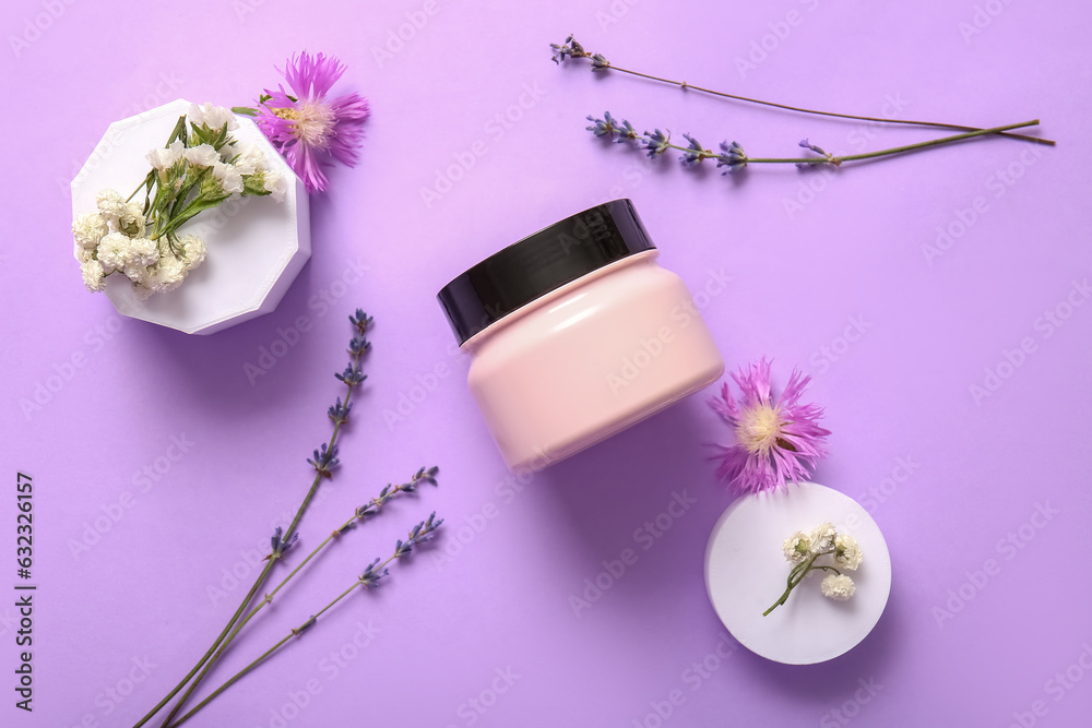 Composition with jar of cosmetic product and flowers on lilac background