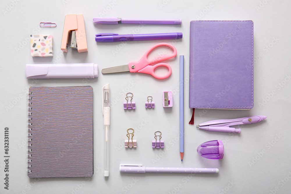 Different school stationery and notebooks on grey background