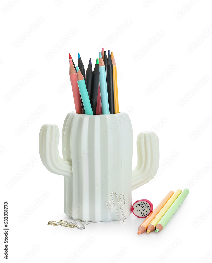 Holder with different color pencils and paper clips on white background