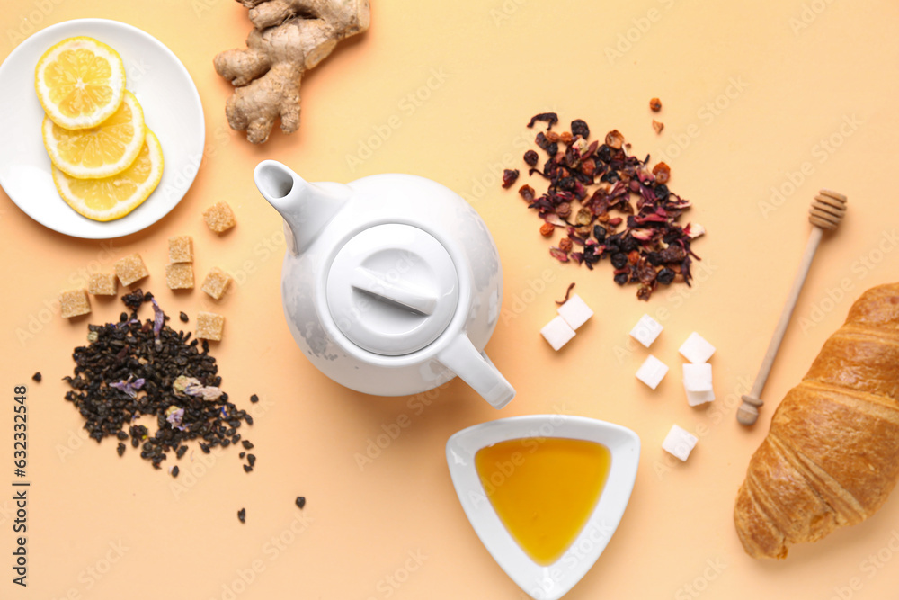 Composition with teapot, dried tea, honey and sugar on color background