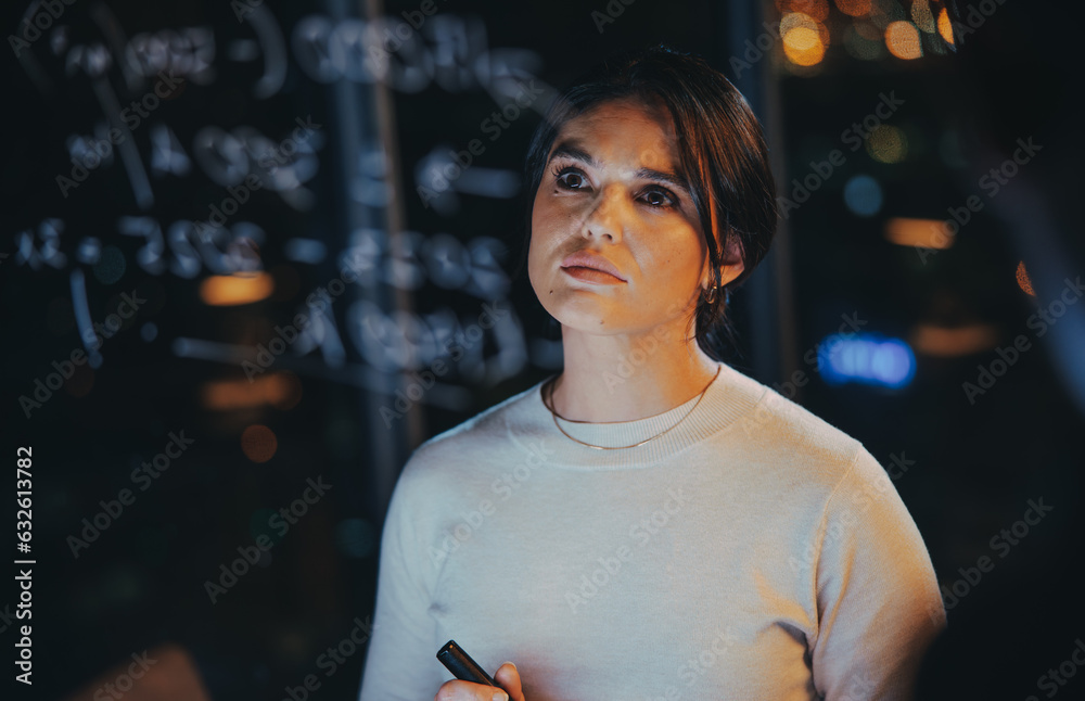 Female data analyst working late in her office