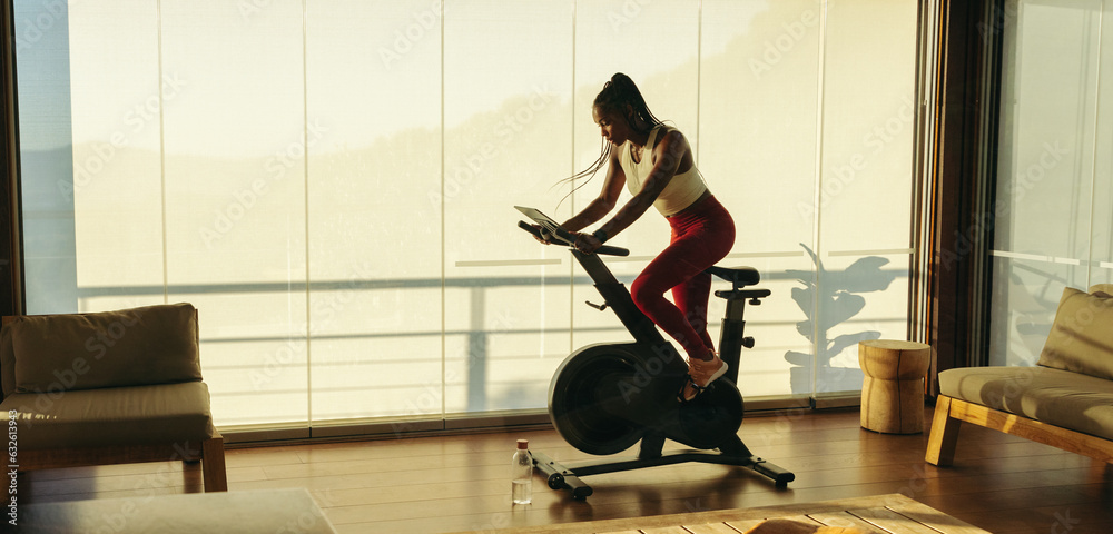 Athletic black woman exercising with fitness equipment at home