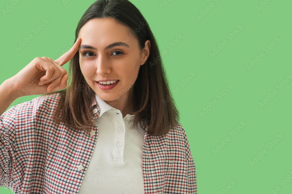 Thinking young woman on green background, closeup