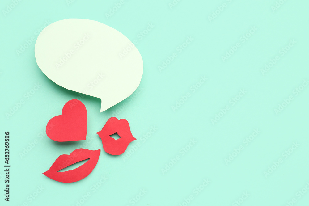 Paper lips and heart with blank speech bubble on turquoise background