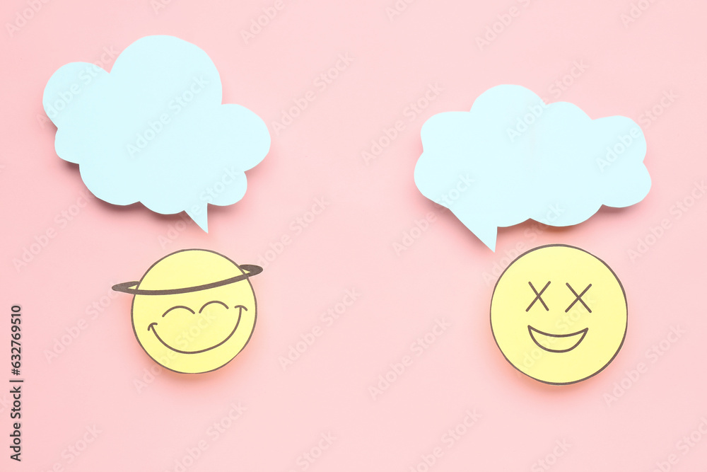 Happy paper faces with blank speech bubbles on pink background