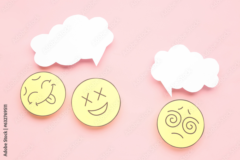 Paper faces with blank speech bubbles on pink background