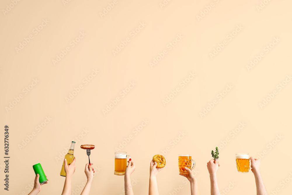 People with beer and sausages on beige background