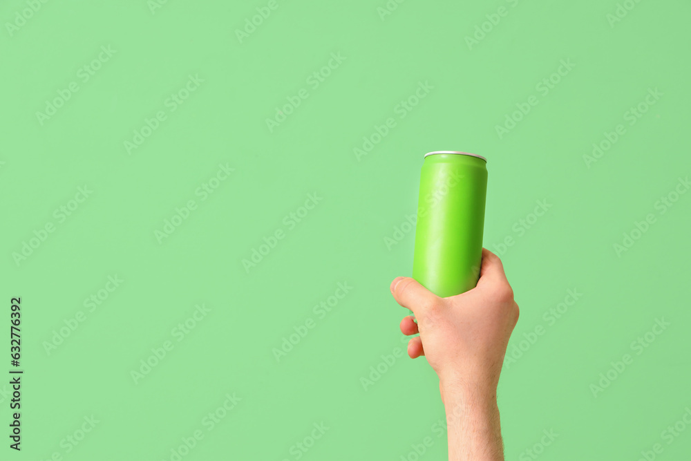 Man with can of beer on green background