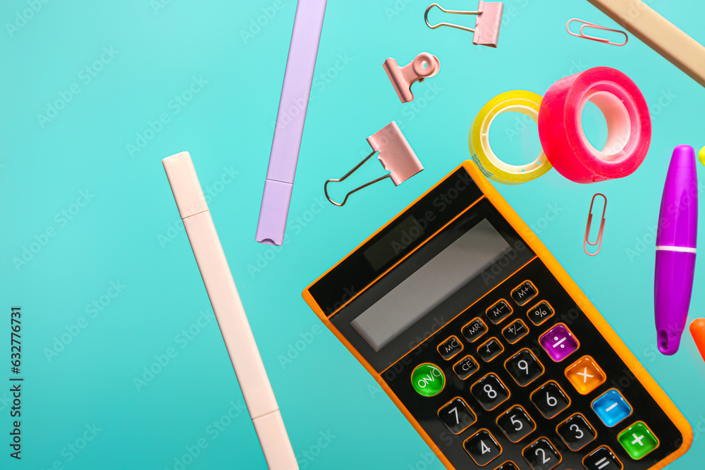 Flying stationery and calculator on color background