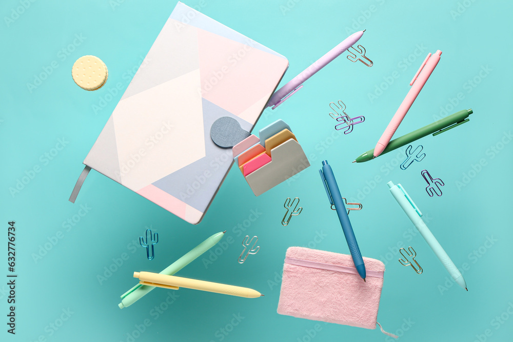 Flying school supplies on color background