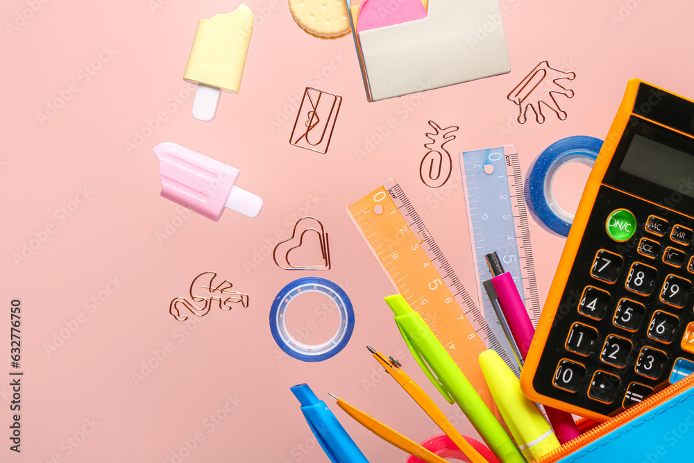 Different stationery with calculator flying on pink background