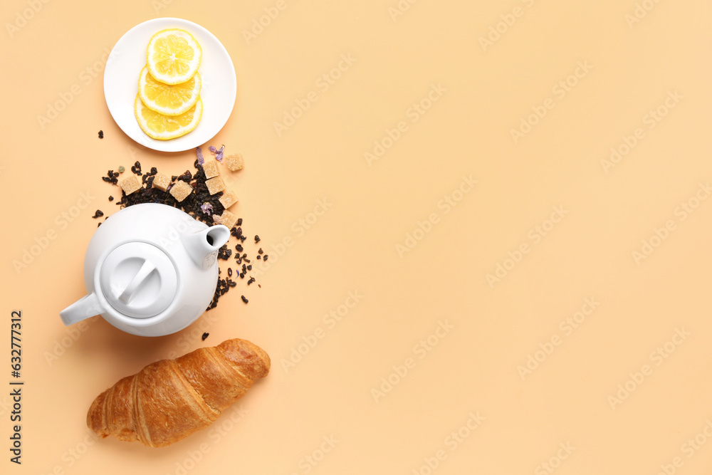 Composition with teapot, croissant and lemon slices on color background