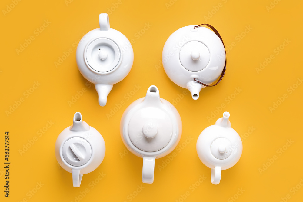 Composition with different teapots on color background