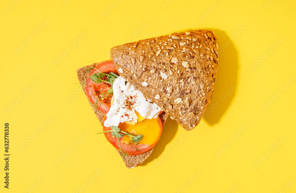 Tasty sandwich with egg on yellow background