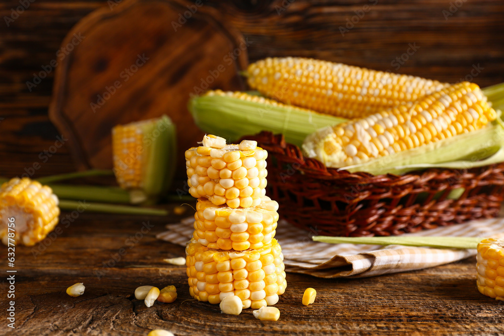 Cut fresh corn cob on wooden background