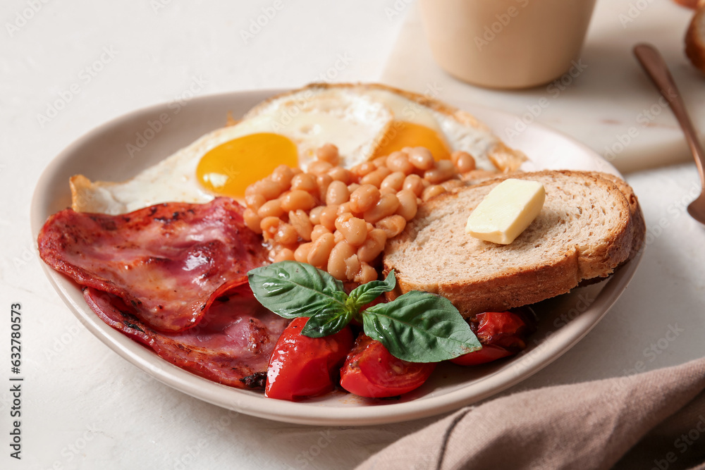 Plate of tasty English breakfast with fried eggs on white background