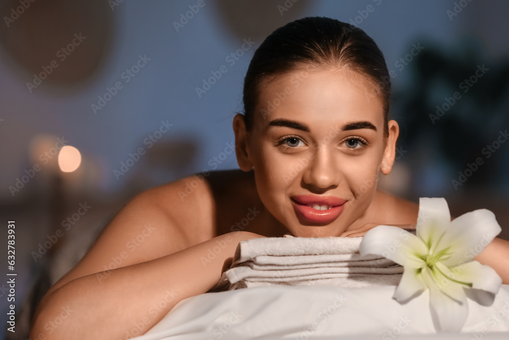 Pretty young woman relaxing in spa salon