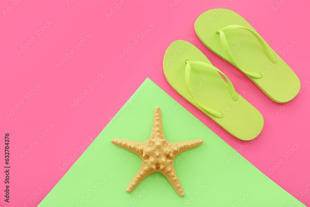 Pair of green flip flops and starfish on colorful background