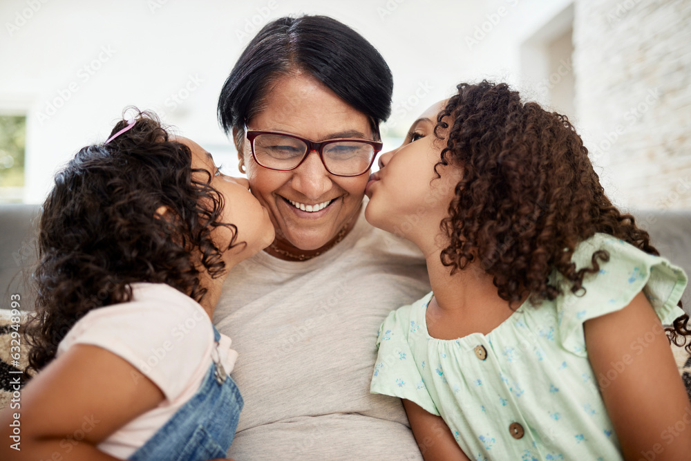 Kids kissing their grandmother on the cheek with care, love and happiness while relaxing in the livi